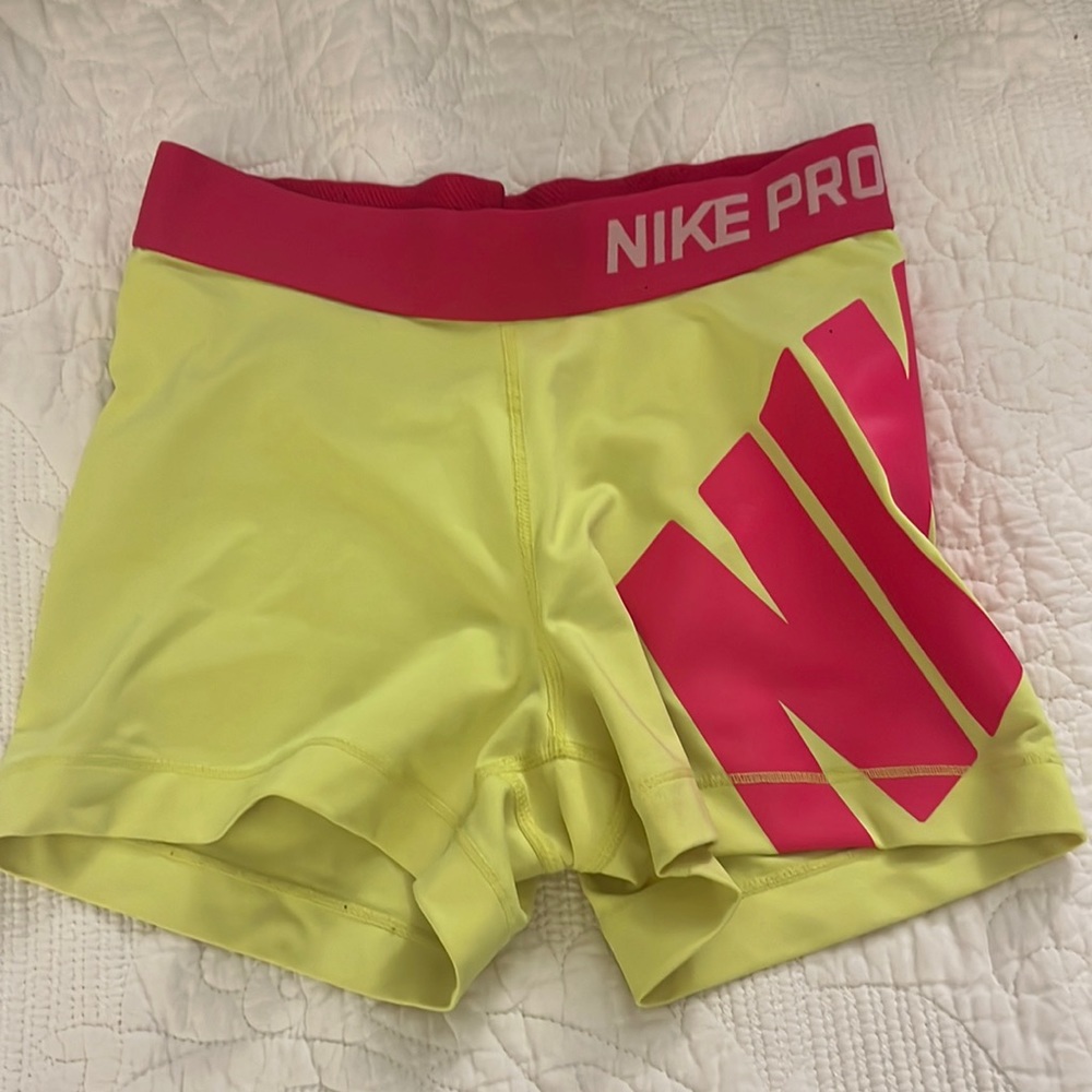 Bright pink and yellow Nike Pros